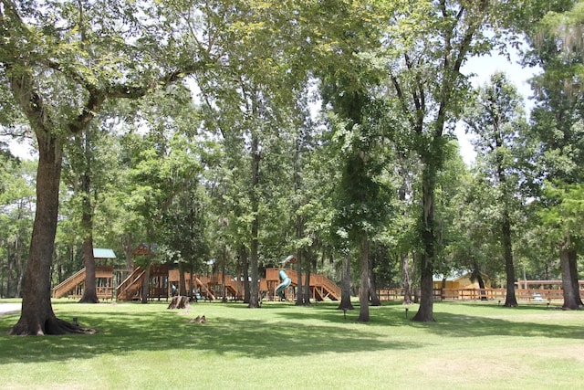 view of property's community with a playground and a lawn