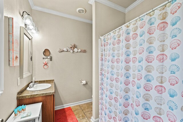 bathroom featuring tile patterned floors, crown molding, and vanity