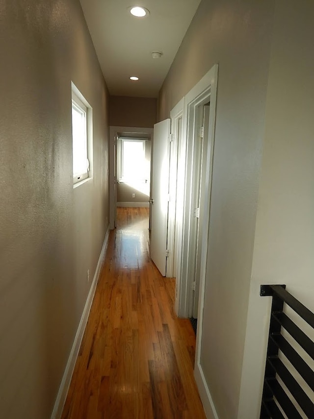 hallway with wood-type flooring