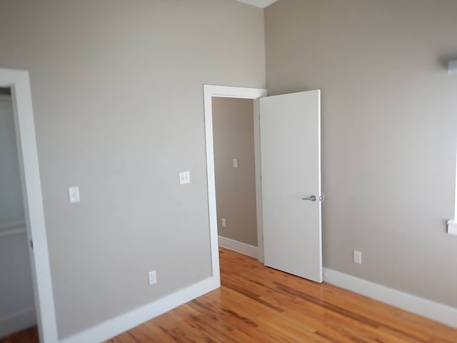 unfurnished room with hardwood / wood-style floors