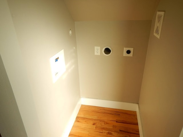 laundry room with electric dryer hookup and hardwood / wood-style flooring