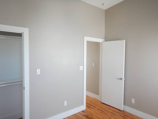 unfurnished bedroom with light hardwood / wood-style flooring and a closet