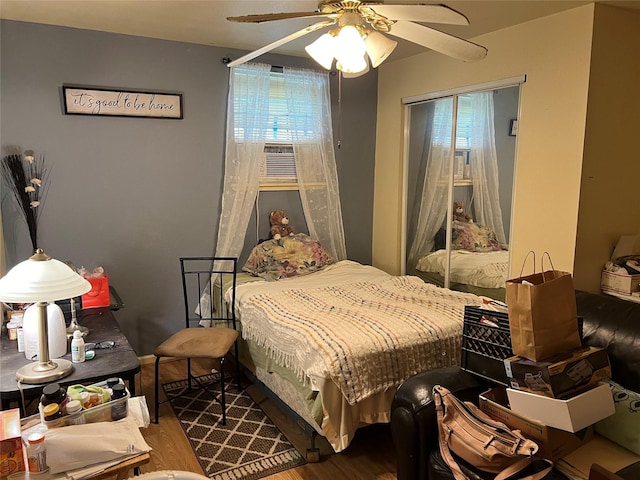 bedroom featuring wood-type flooring, ceiling fan, and cooling unit