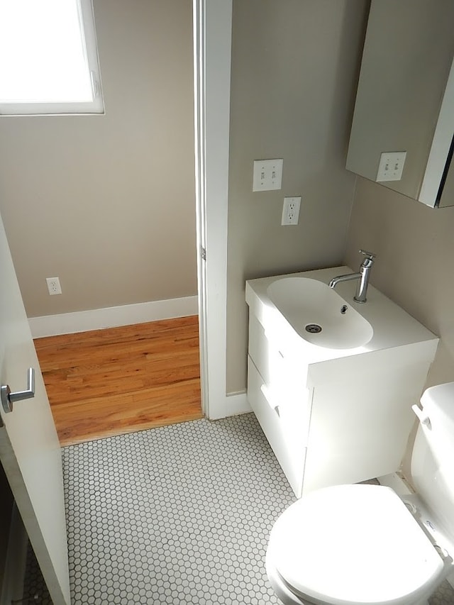 bathroom with tile flooring, vanity, and toilet