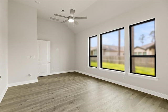 spare room with hardwood / wood-style floors, ceiling fan, and lofted ceiling