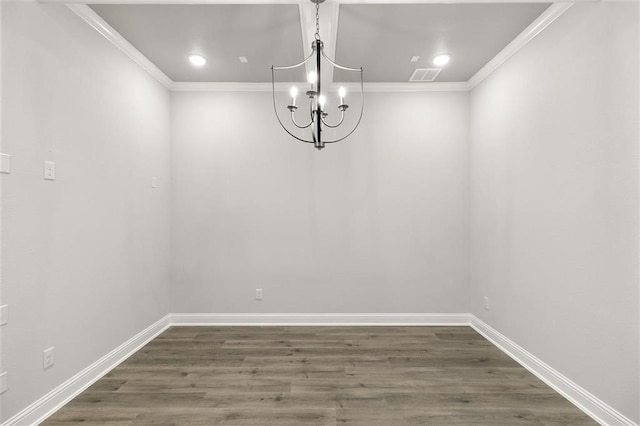 unfurnished dining area featuring crown molding, dark wood-type flooring, and a notable chandelier