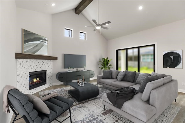 living room with beam ceiling, ceiling fan, high vaulted ceiling, light hardwood / wood-style floors, and a fireplace