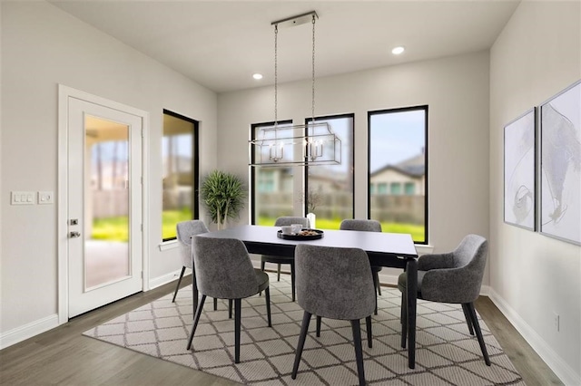 dining room with wood-type flooring and a notable chandelier