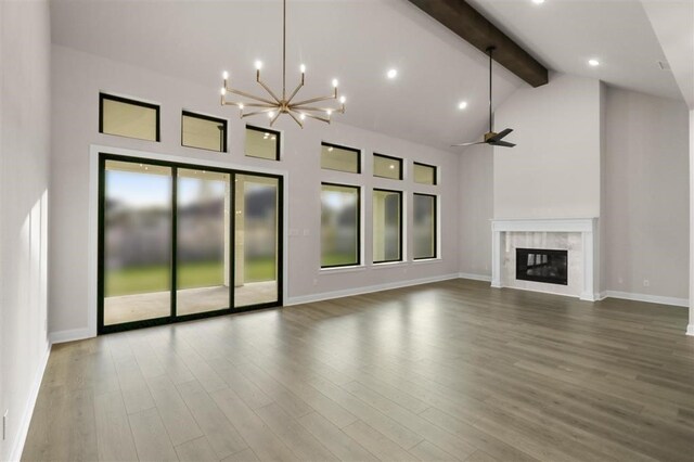 unfurnished living room with a premium fireplace, ceiling fan with notable chandelier, high vaulted ceiling, and beamed ceiling