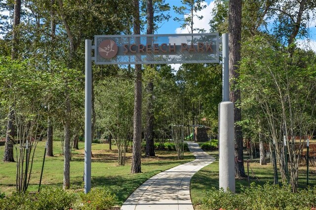 view of property's community with a lawn