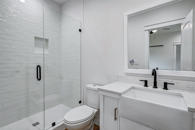 bathroom featuring vanity, toilet, and walk in shower