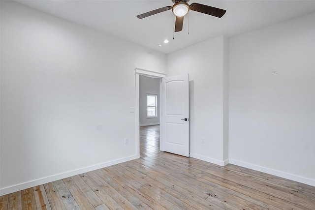 empty room with ceiling fan and light wood-type flooring