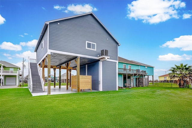 rear view of property featuring cooling unit and a lawn