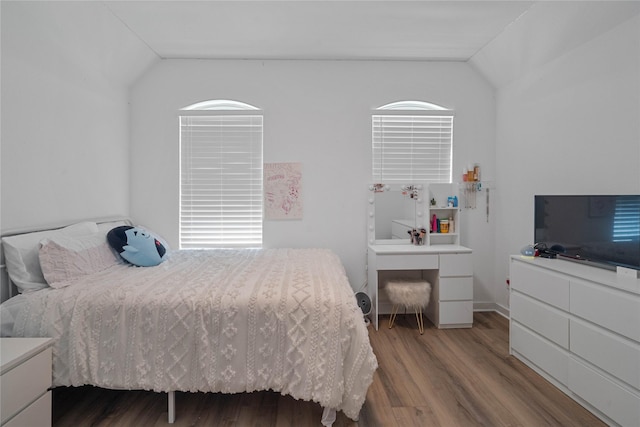 bedroom with hardwood / wood-style floors and vaulted ceiling