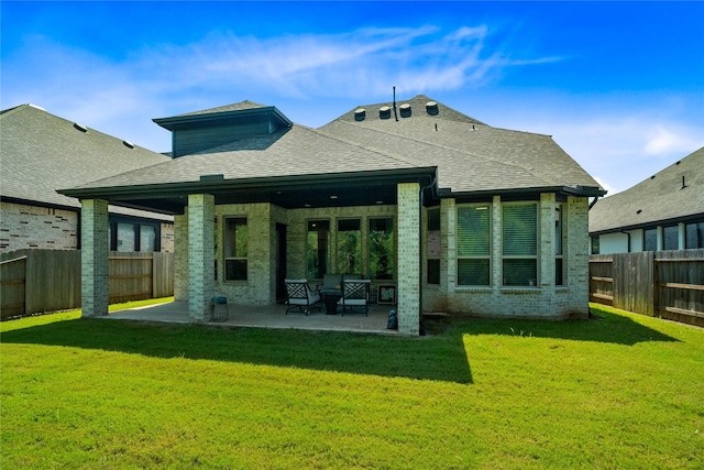 rear view of property featuring a patio area and a yard