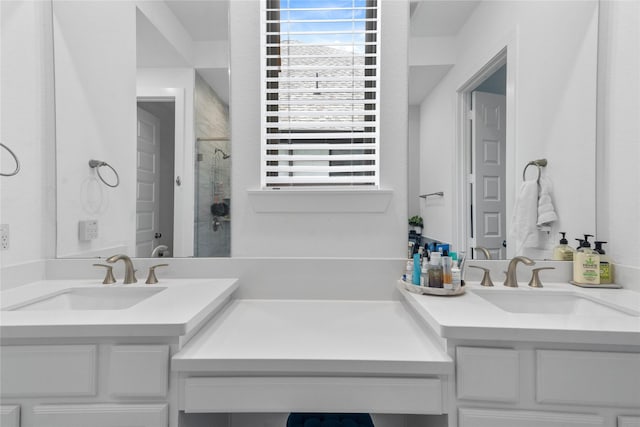 bathroom with a tile shower and vanity