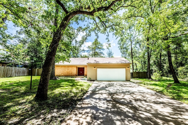 ranch-style house featuring a garage and a front yard