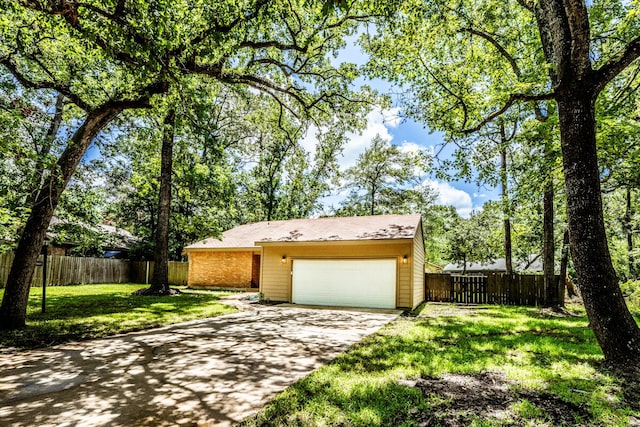 single story home with a garage and a front yard