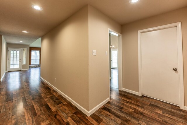 hallway with hardwood / wood-style floors