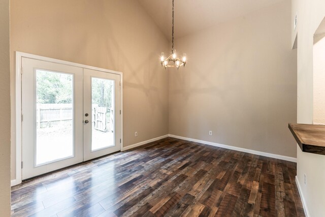 doorway to outside with high vaulted ceiling, french doors, wood-type flooring, and a notable chandelier