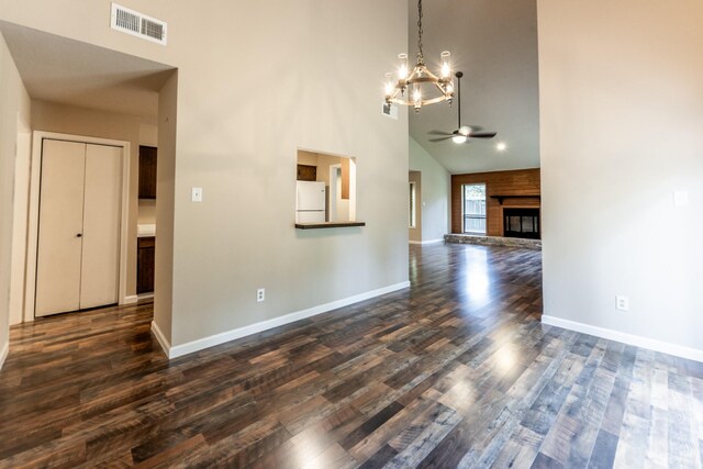 interior space with ceiling fan with notable chandelier, dark hardwood / wood-style flooring, and high vaulted ceiling