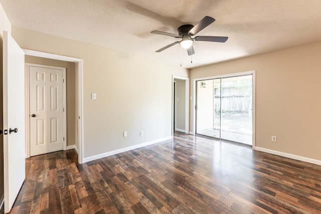 unfurnished room with dark hardwood / wood-style floors, a textured ceiling, and ceiling fan