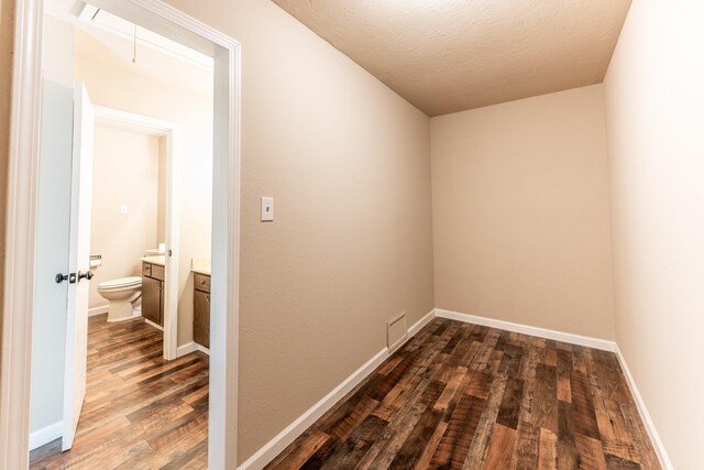 hallway featuring a textured ceiling and hardwood / wood-style floors