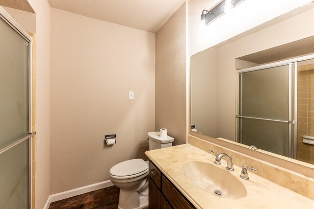 bathroom with vanity, toilet, and walk in shower