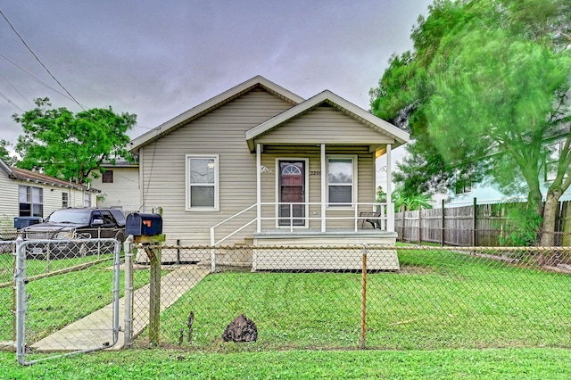 view of front of house with a front yard and a porch