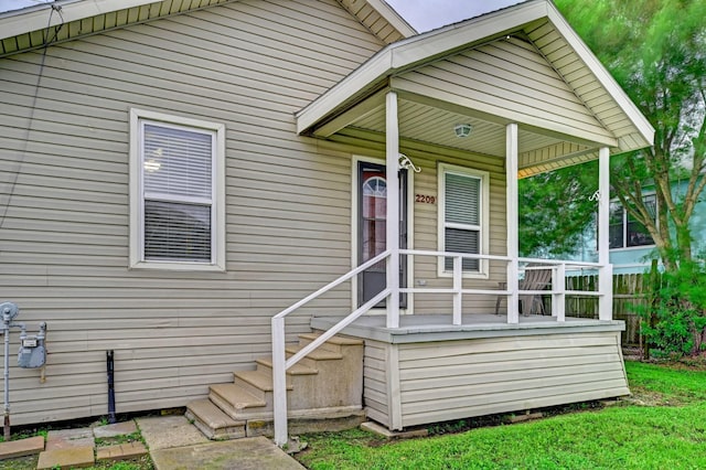 view of exterior entry with a porch