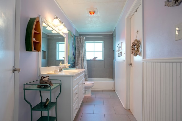 full bathroom featuring vanity, tile patterned flooring, crown molding, shower / bath combination with curtain, and toilet