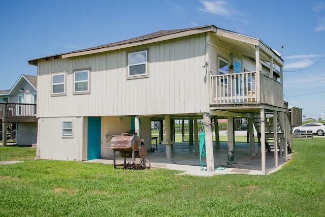 rear view of property featuring a patio and a yard