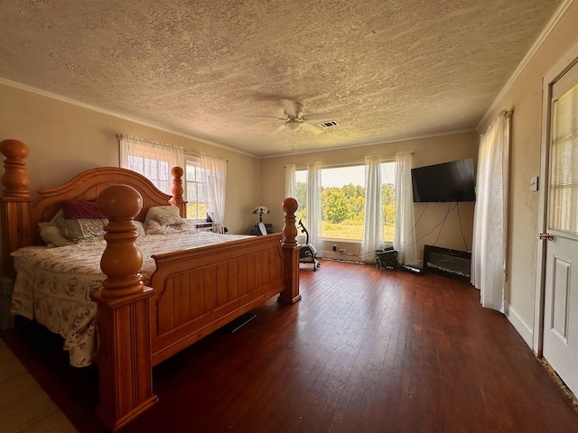 bedroom featuring dark hardwood / wood-style flooring, multiple windows, and ornamental molding