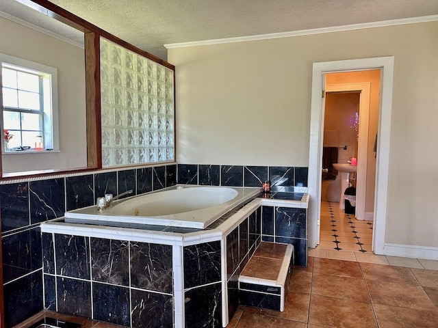 bathroom with a relaxing tiled tub, crown molding, tile patterned floors, and a textured ceiling