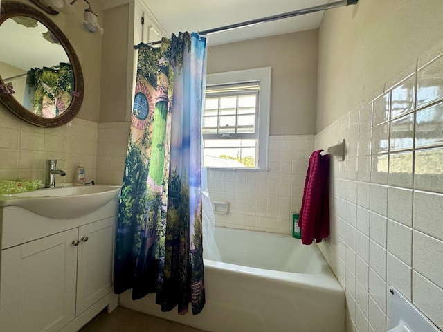 bathroom featuring backsplash, tile walls, vanity, and shower / tub combo with curtain