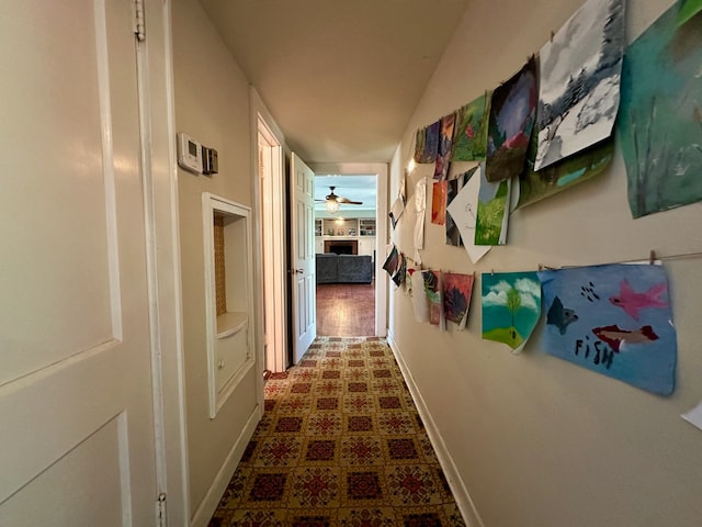 hallway featuring dark tile floors