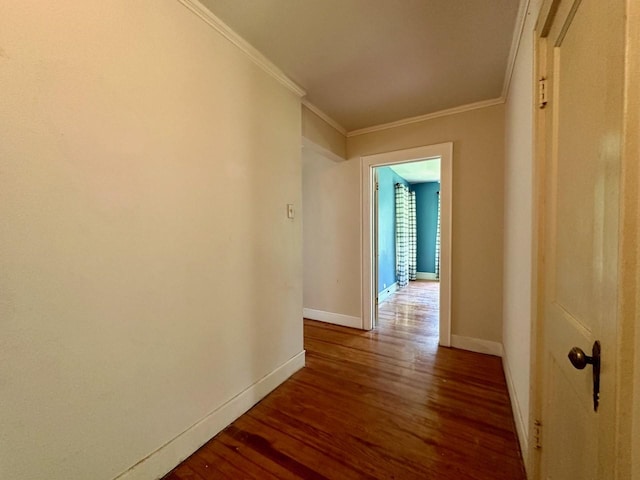 hallway featuring ornamental molding and dark hardwood / wood-style flooring