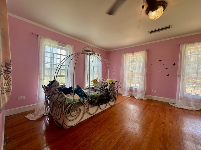 miscellaneous room with crown molding and hardwood / wood-style floors