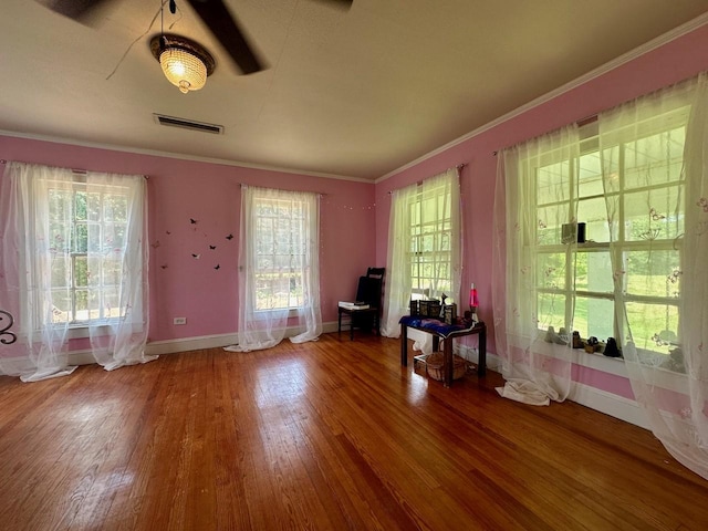 interior space with hardwood / wood-style flooring and ornamental molding