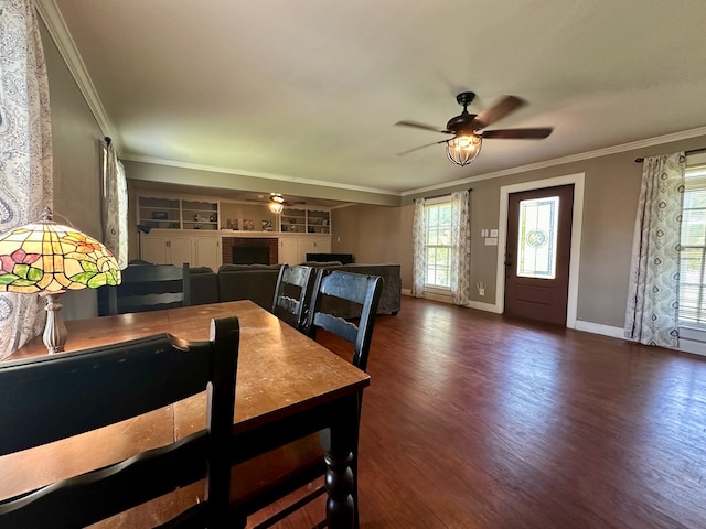 dining room featuring crown molding, dark wood-type flooring, ceiling fan, and built in features