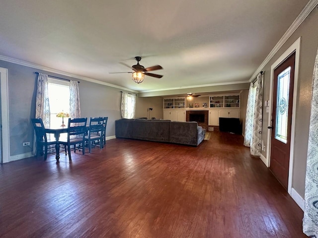 unfurnished living room featuring crown molding, a fireplace, dark hardwood / wood-style floors, and ceiling fan