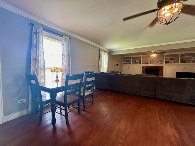 dining space featuring a brick fireplace, ornamental molding, and ceiling fan