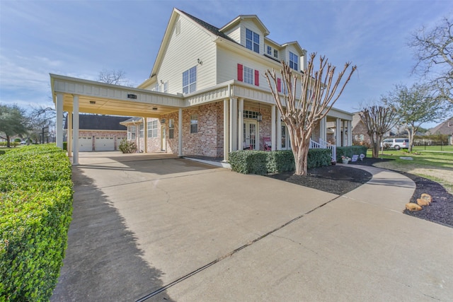 view of front of home featuring a carport, a garage, and covered porch