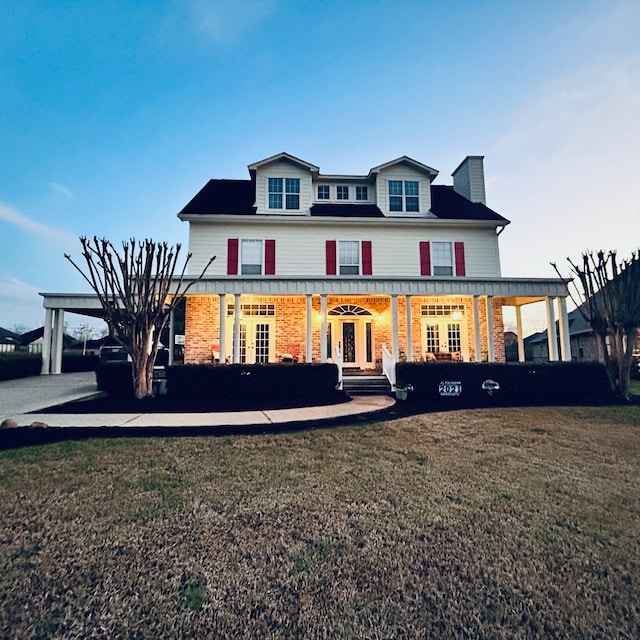 view of front of home with a front yard and covered porch