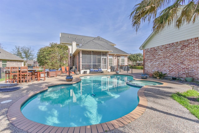 view of pool with a patio, exterior bar, and an in ground hot tub