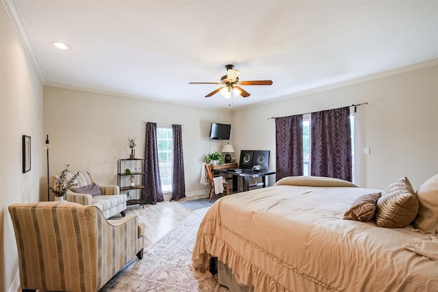 bedroom with ceiling fan, ornamental molding, and wood-type flooring