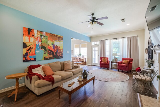 living room featuring ornamental molding, wood-type flooring, and ceiling fan