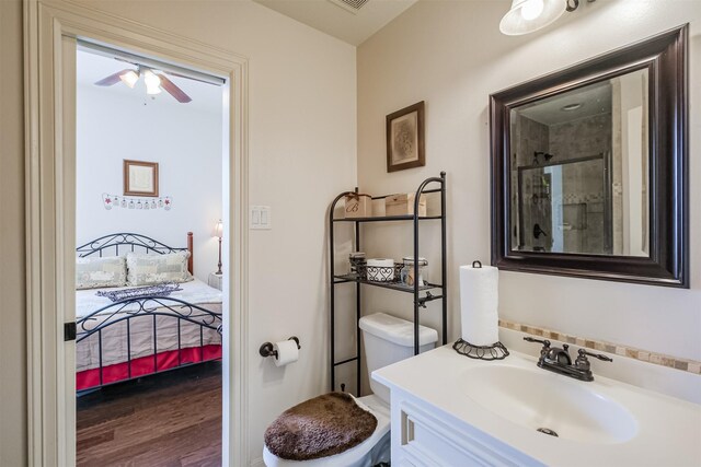 bathroom with ceiling fan, hardwood / wood-style floors, toilet, and vanity