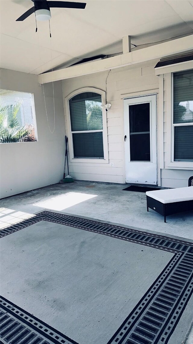 entrance to property featuring a patio and ceiling fan