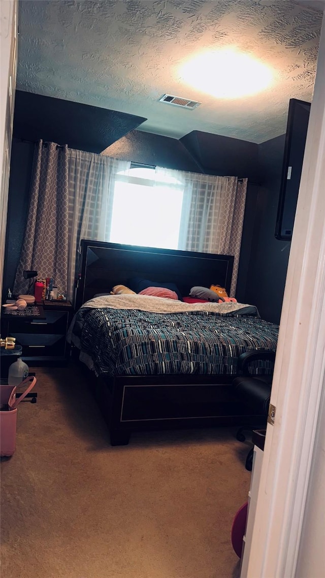 carpeted bedroom featuring a textured ceiling